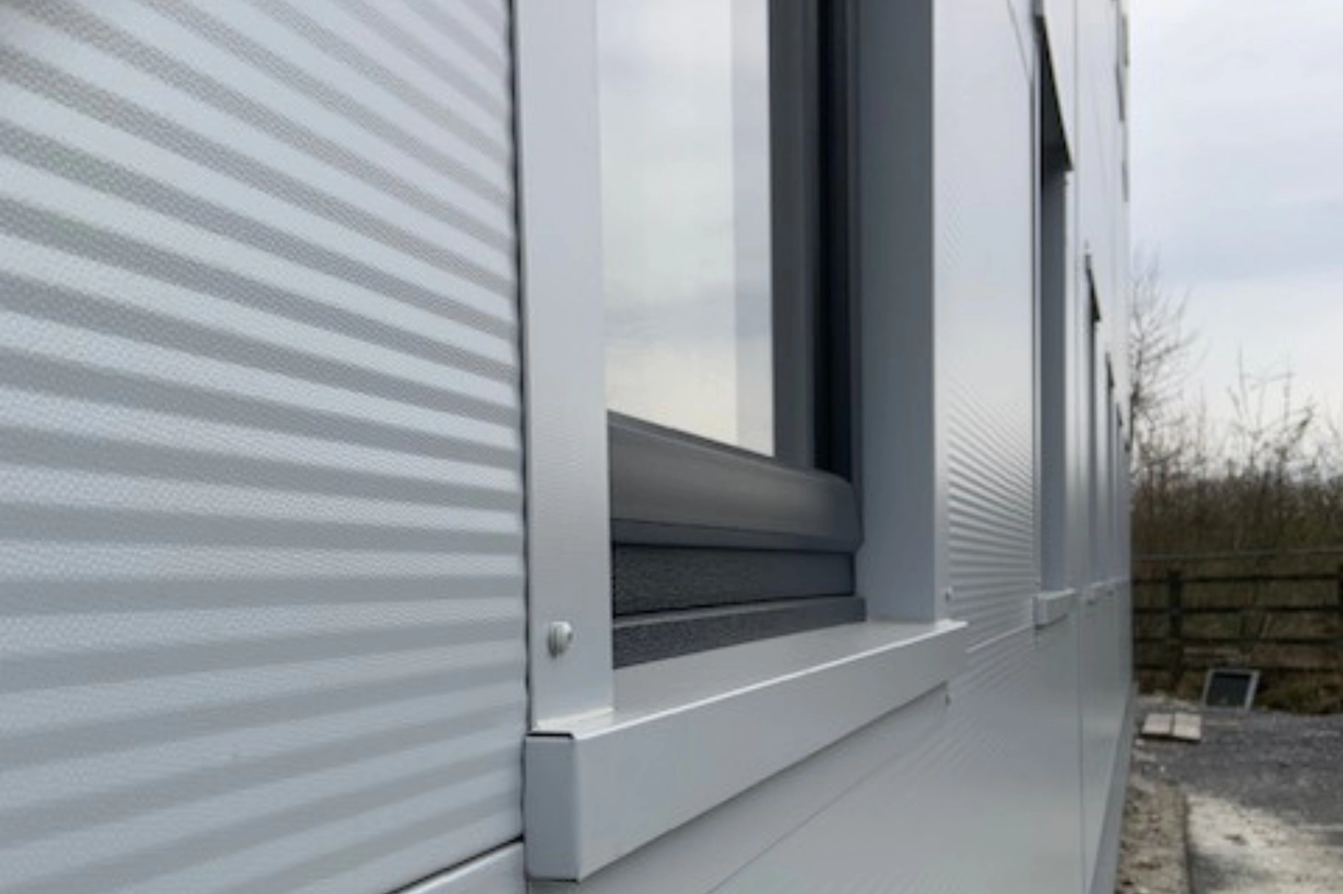 Close-up of roof edge flashings being fitted